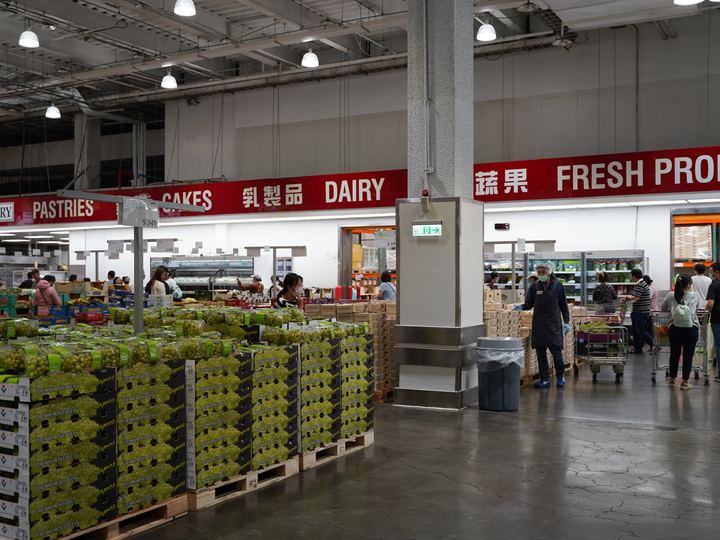 Wide aisles and tall pallet shelving inside a Costco warehouse in Kaohsiung, Taiwan