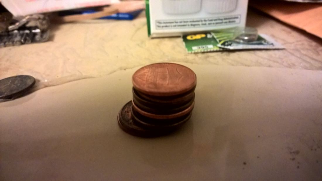 A tall stack of copper one-cent coins
